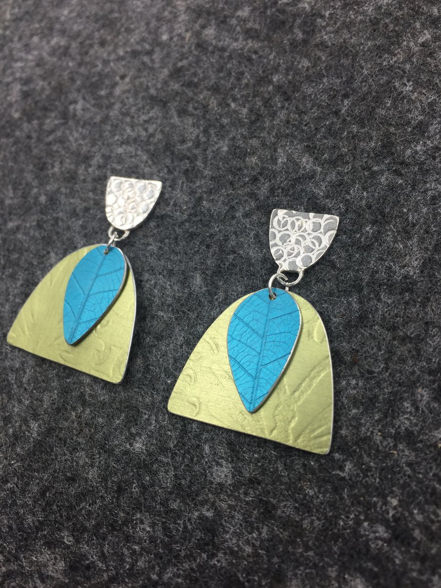 Handmade silver and aluminium textured earrings in turquoise and pale green