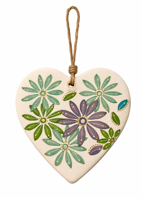 Ceramic heart with hand drawn design.