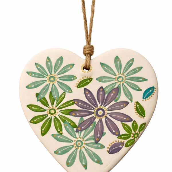 Ceramic heart with hand drawn design.