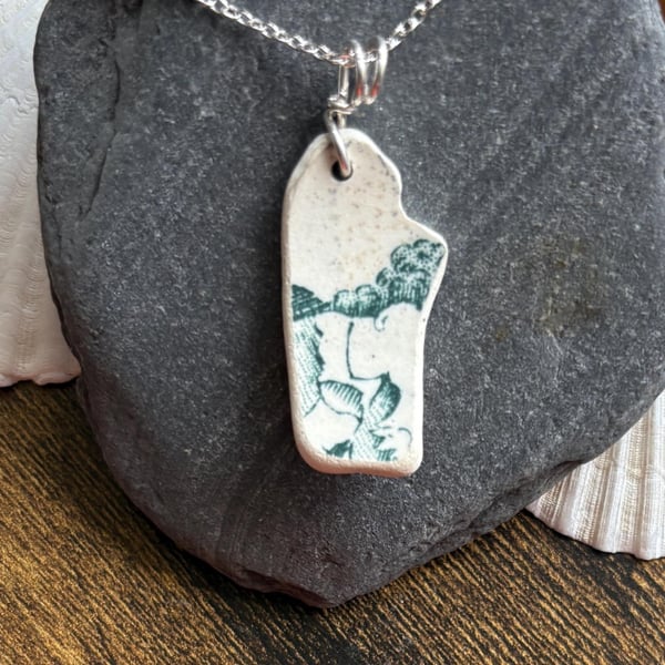 Sea pottery necklace, green design, smooth natural shape.