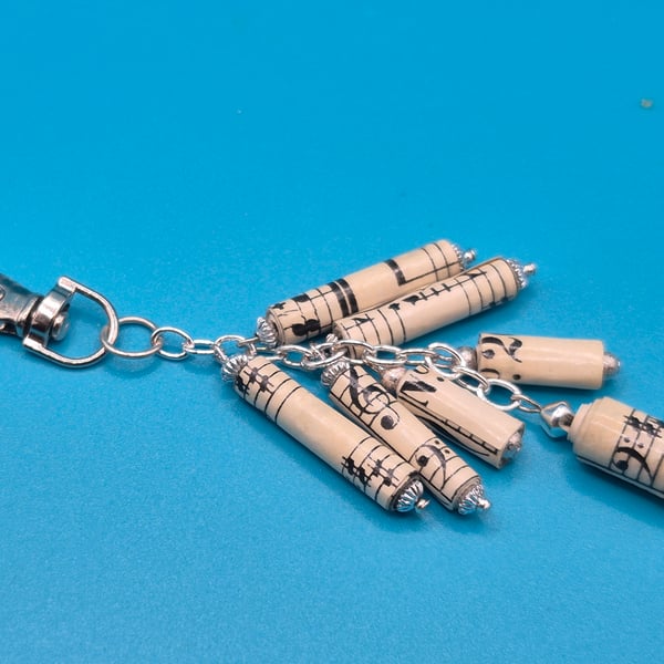 Paper beaded keyring made with recycled music sheets