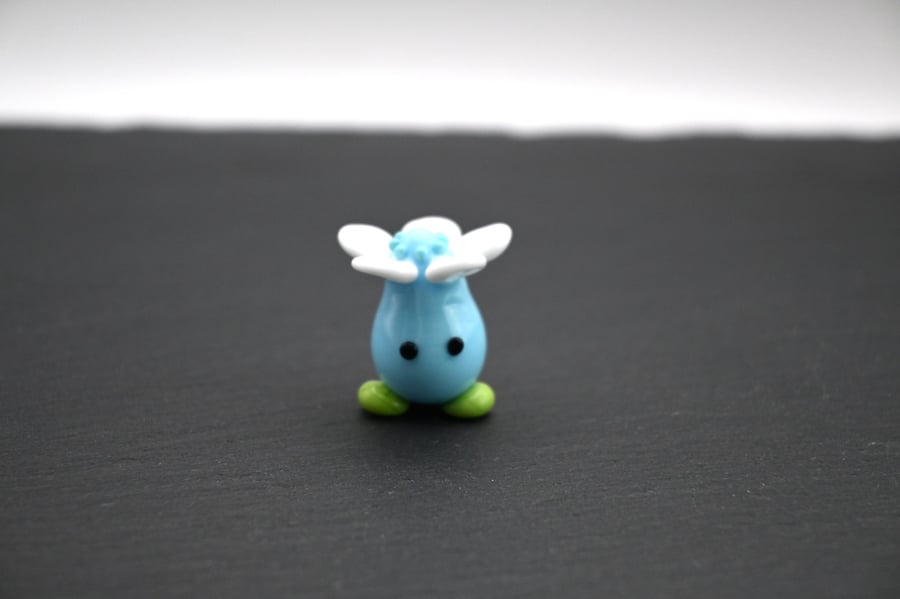 blue glass flower head figure
