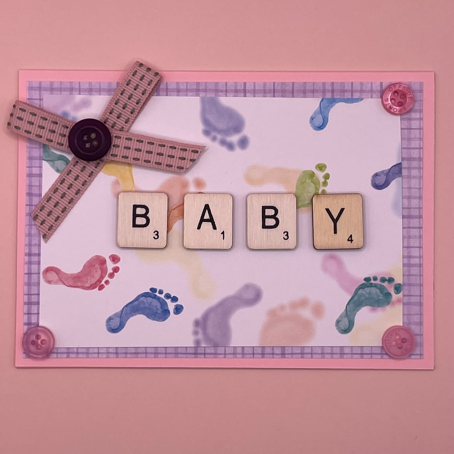 Baby card with cute footprints and wooden letters
