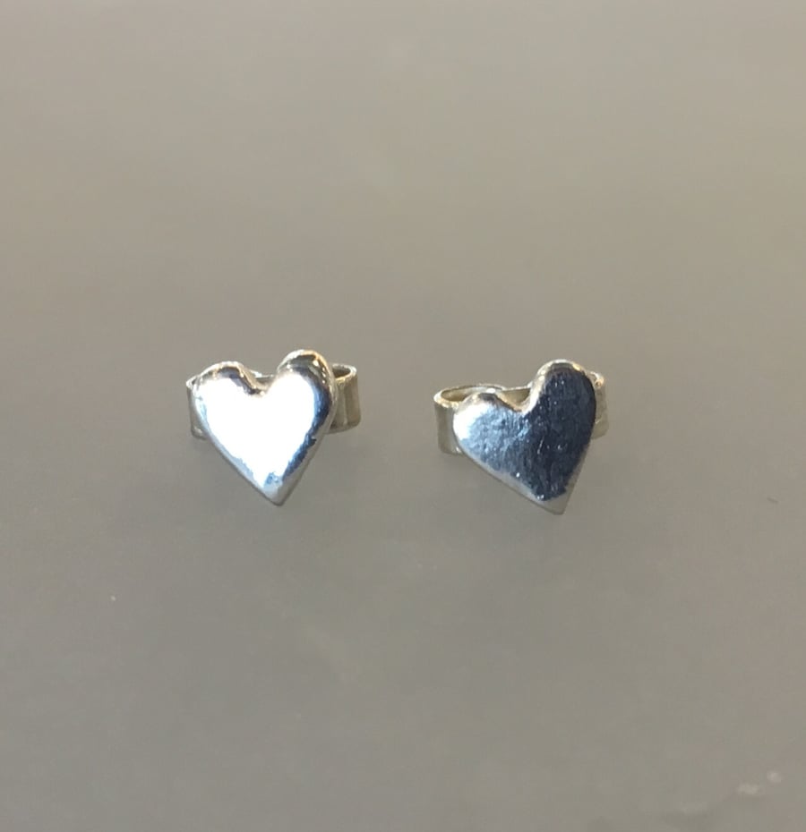 Tiny silver heart earrings.