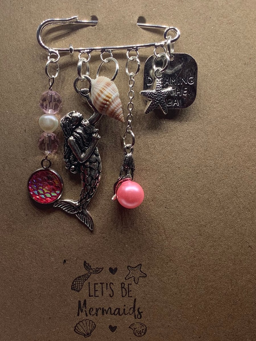 Handmade kilt pin mermaid themed brooch, attached to kraft greetings card.