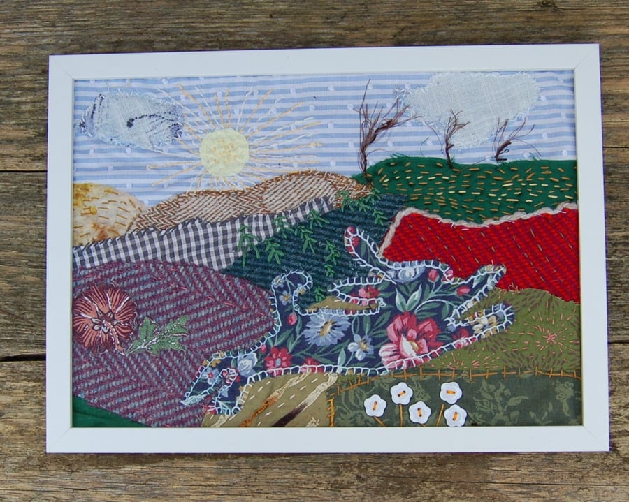 Upcycled Leaping hare landscape. Handstitched onto fabric pieces.