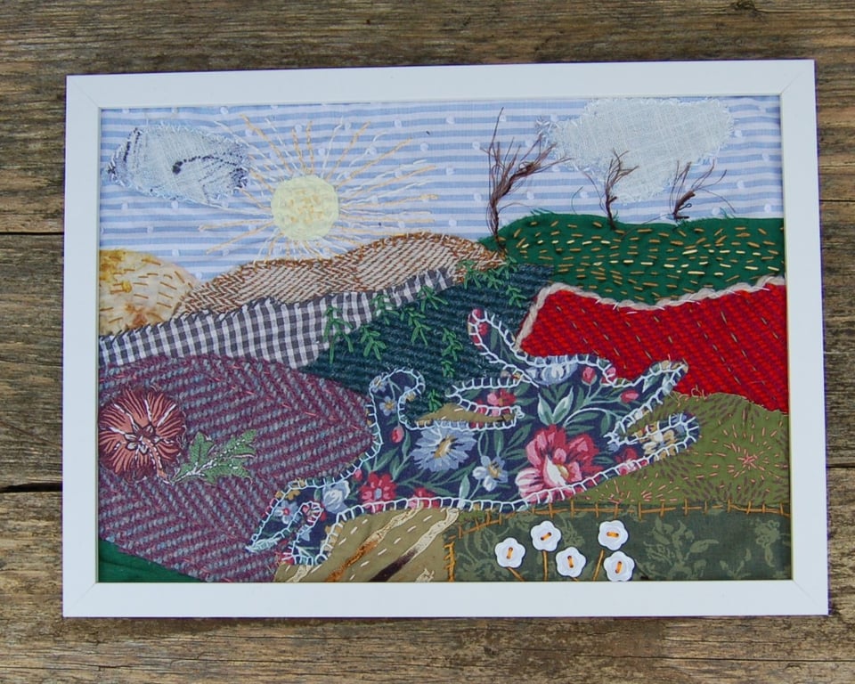 Upcycled Leaping hare landscape. Handstitched onto fabric pieces.