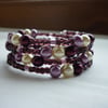 BURGUNDY, OFF WHITE AND LILAC FROST MEMORY WIRE BRACELET.  416