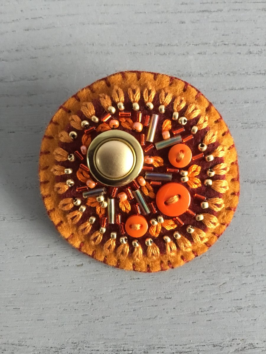 Orange brooch sale