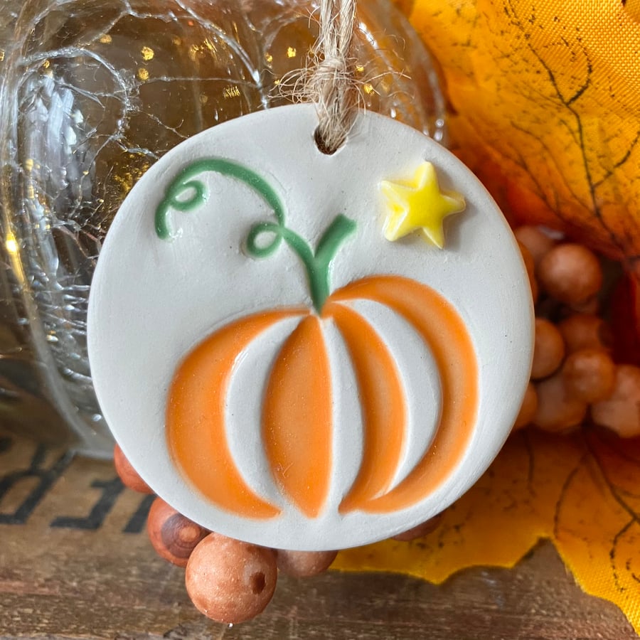 Small ceramic pumpkin decoration with star