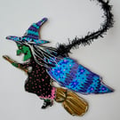 Flying Witch ornament with flowers on cape by Kat Hazelton