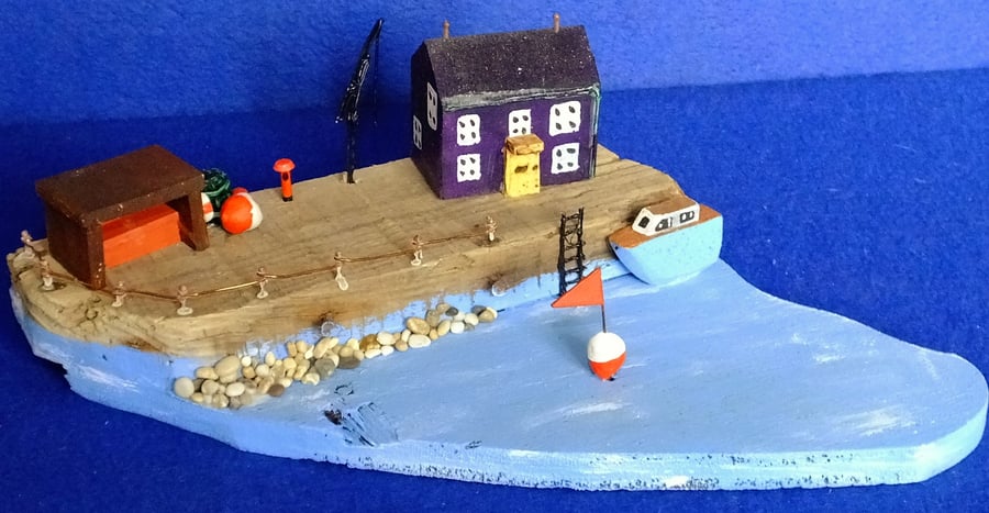 Driftwood seaside harbour quayside scene with fishing boat blue sea & buoys