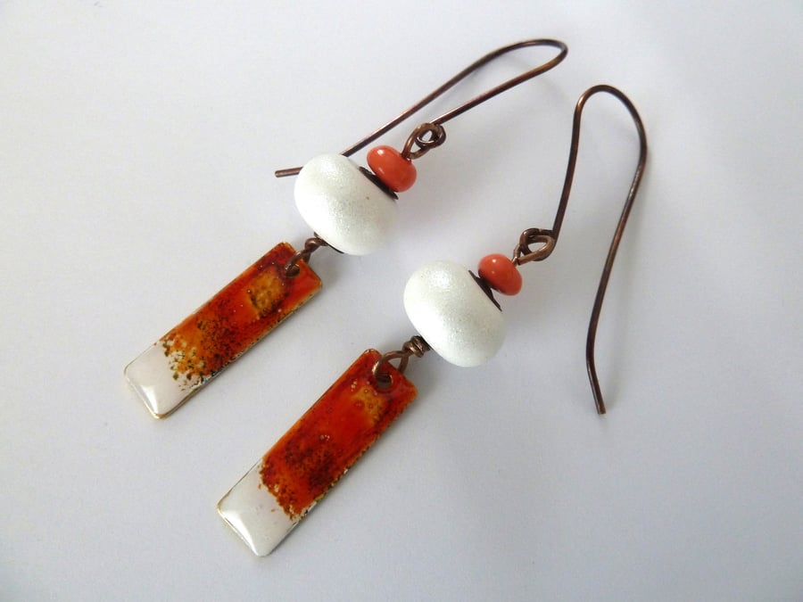white and orange earrings