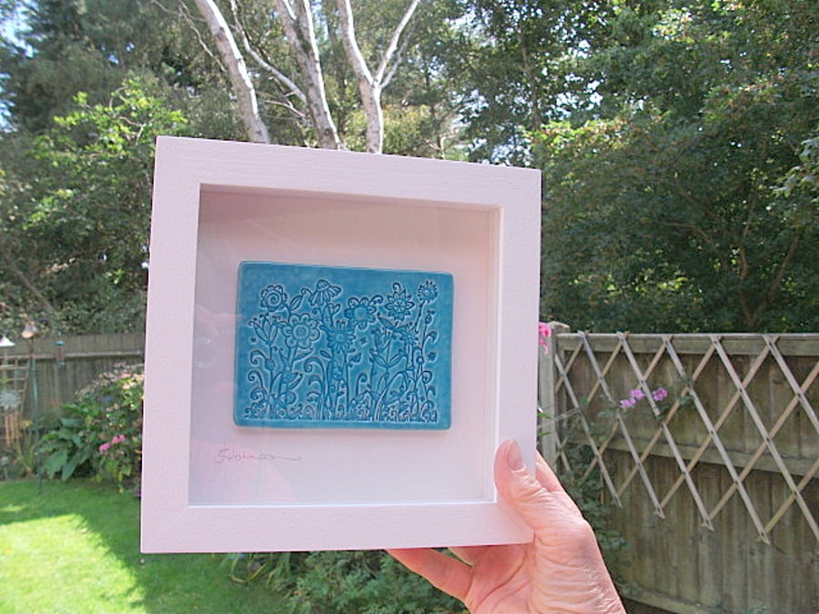 Ceramic turquoise floral picture in a rustic white wood frame
