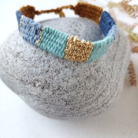 Narrow rustic festival bracelet in blue, turquoise, tan and gold stripe