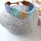Narrow rustic festival bracelet in blue, turquoise, tan and gold stripe