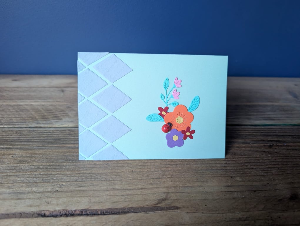 Handmade floral design card with ladybird embellishment