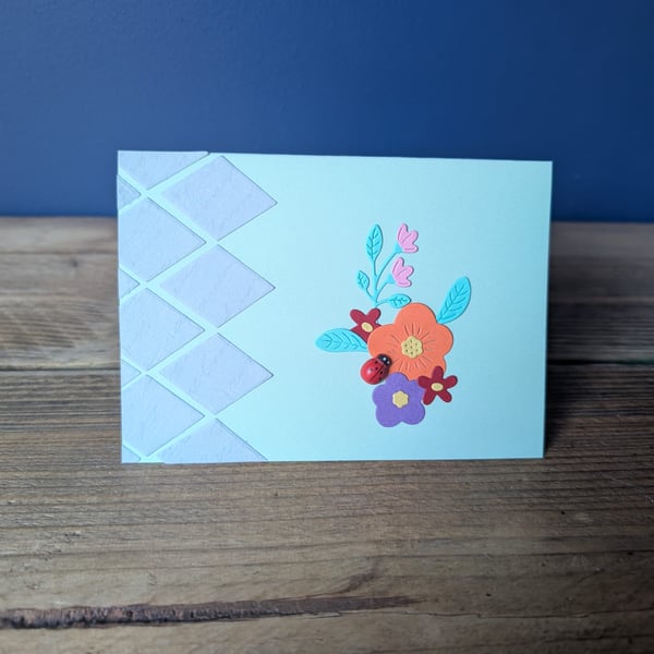Handmade floral design card with ladybird embellishment