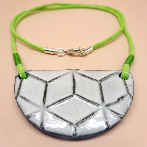 Geometric ceramic bib necklace on a lime green cord