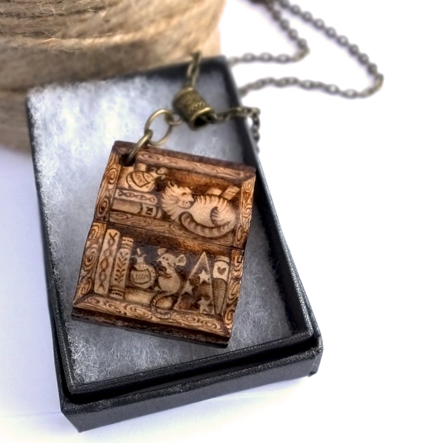 Book shaped bookshelf for bookworms. Cat and mouse pyrography pendant necklace.