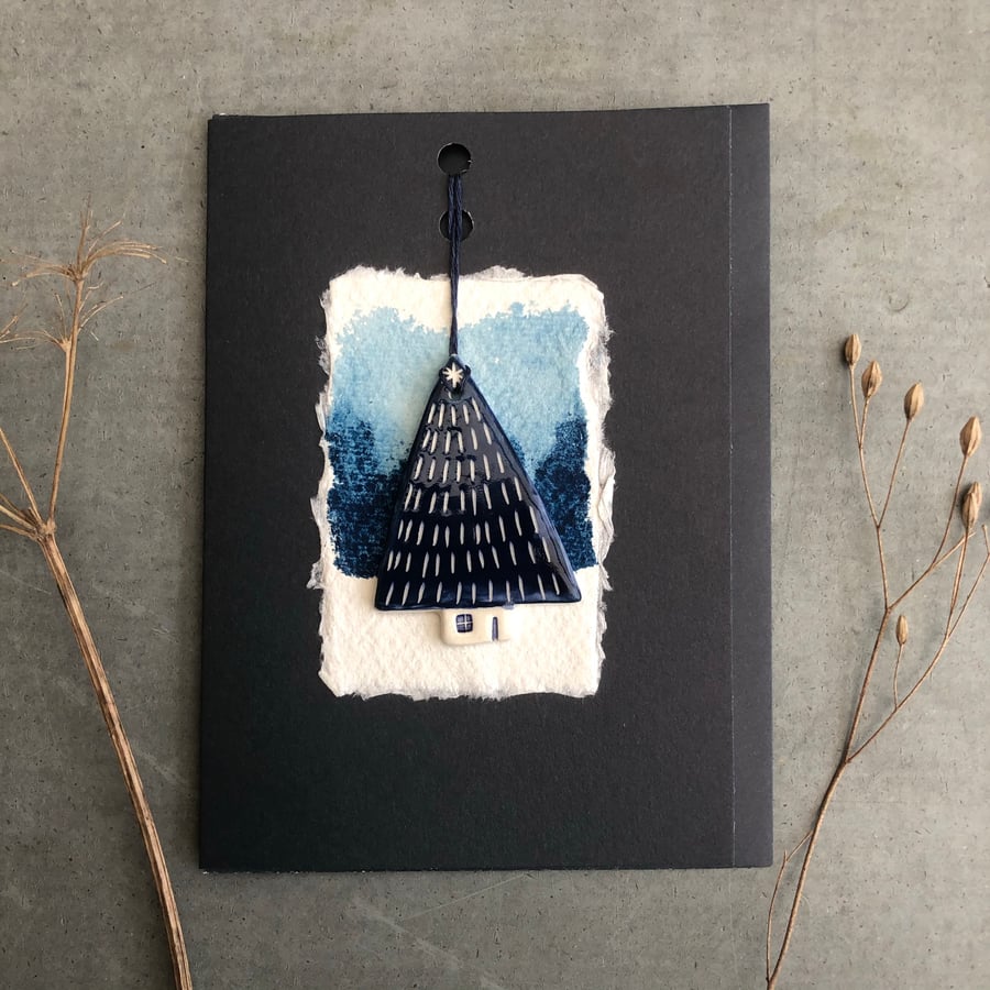 Card with ceramic tree decoration.