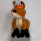 Handcrafted needle felted fox with removable party hat on a wooden box