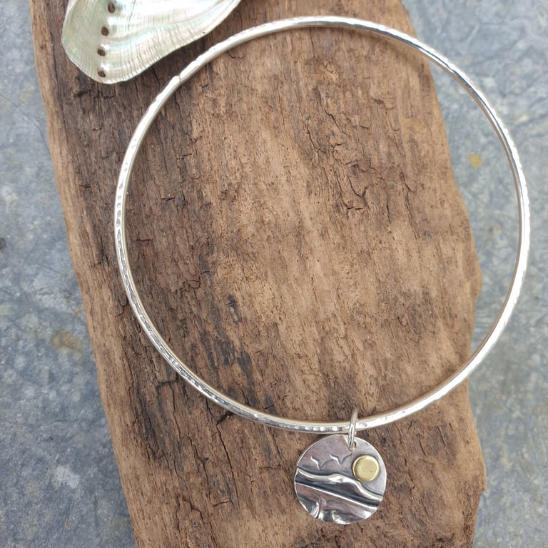 Sterling silver textured bangle with coastal scene charm