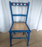 Upcycled vintage chair in blue chalk paint, hearts design, re-caned seat