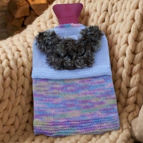 hot water bottle cover with a fluffy teddy in bed design 