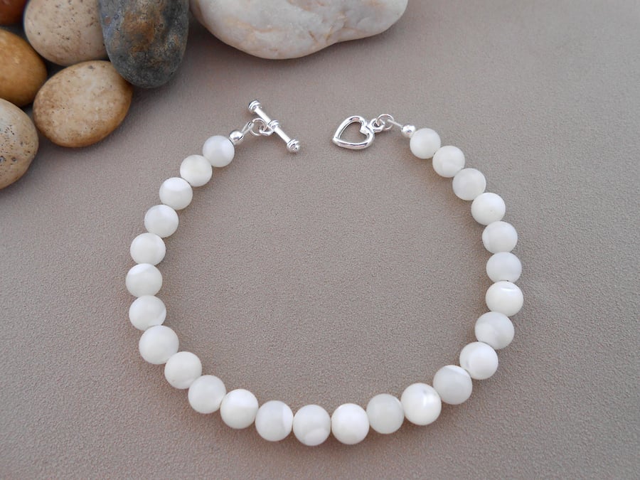 Mother of pearl 7" bracelet with heart clasp.