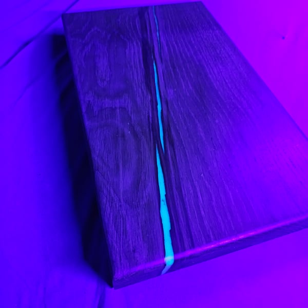 Oak chopping with blue glow in the dark epoxy resin 