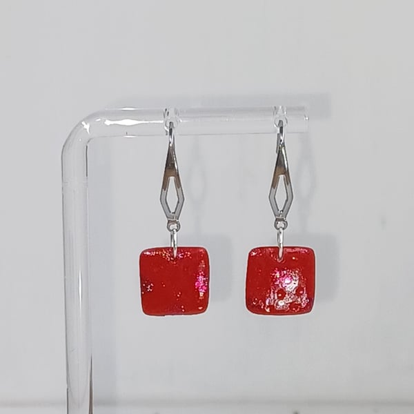 Square dangle earrings with red sparkle and texture detail