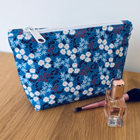 Small cotton makeup bag, pouch, purse, in blue and purple floral design.