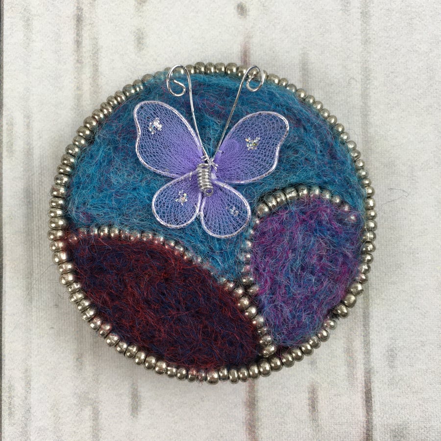 Butterfly brooch, needle felted in blue, red and purple with silver beading