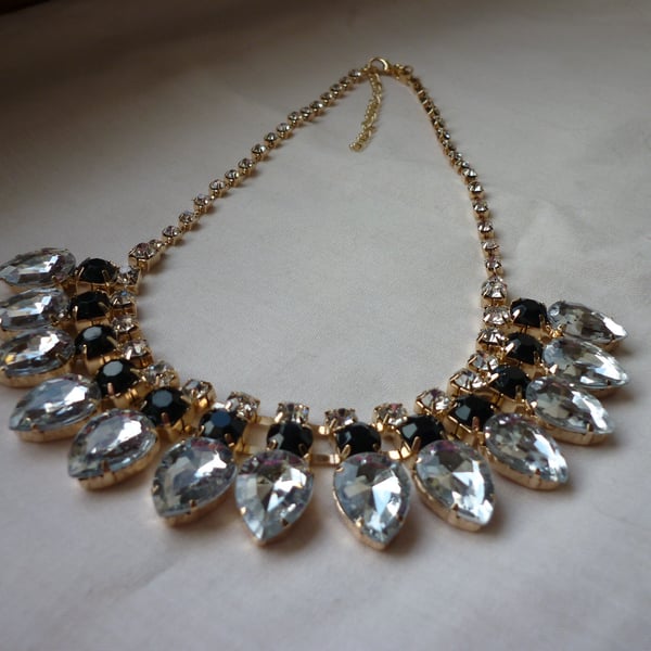 BLACK, CRYSTAL RHINESTONES AND GOLD BIB STYLE NECKLACE.  1029