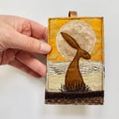 Up-cycled embroidered hare rabbit golden sun home decoration.