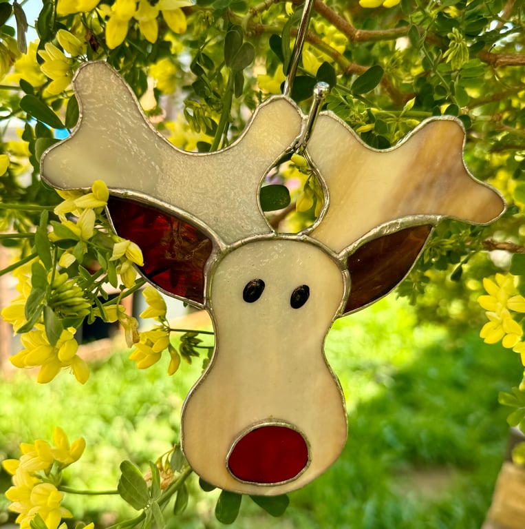 Stained glass reindeer suncatcher decoration in creamy browns with red nose