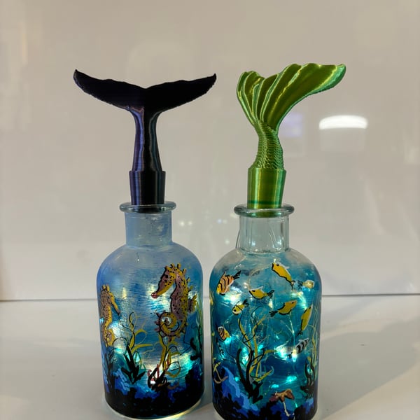 A pair of glass hand painted and fired bottles by Andrew Jenkins 