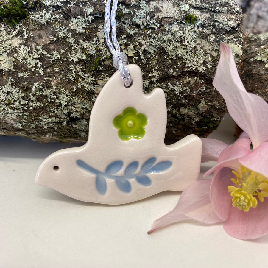 Teeny ceramic dove decoration with blue leaves and green flower