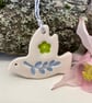 Teeny ceramic dove decoration with blue leaves and green flower