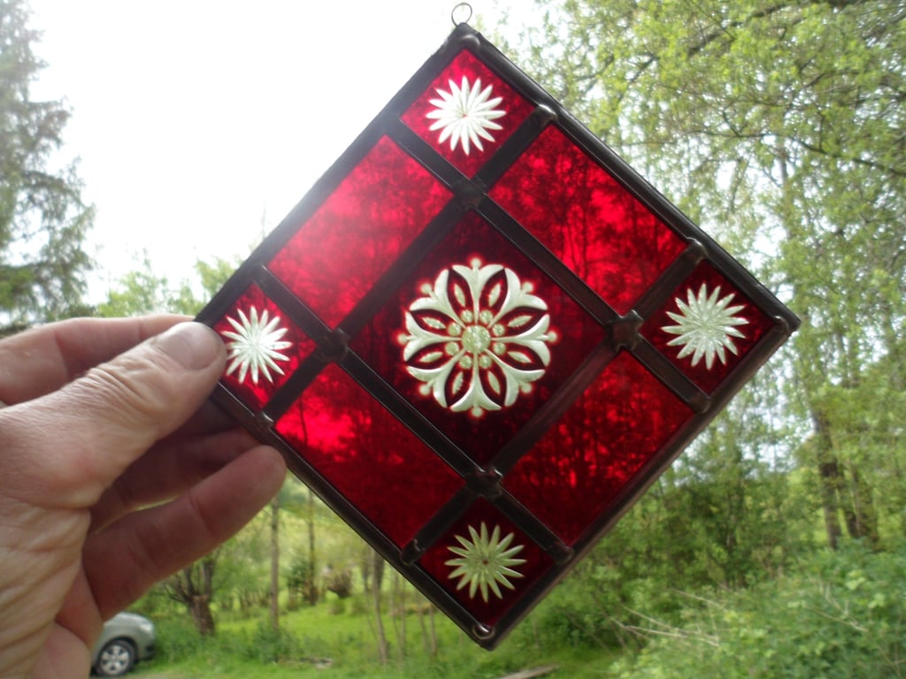 A RED BRILLIANT CUT STAINED GLASS MOBILE SUNCATCHER