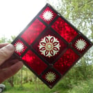 A RED BRILLIANT CUT STAINED GLASS MOBILE SUNCATCHER