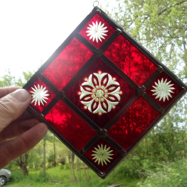 A RED BRILLIANT CUT STAINED GLASS MOBILE SUNCATCHER