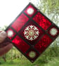 A RED BRILLIANT CUT STAINED GLASS MOBILE SUNCATCHER
