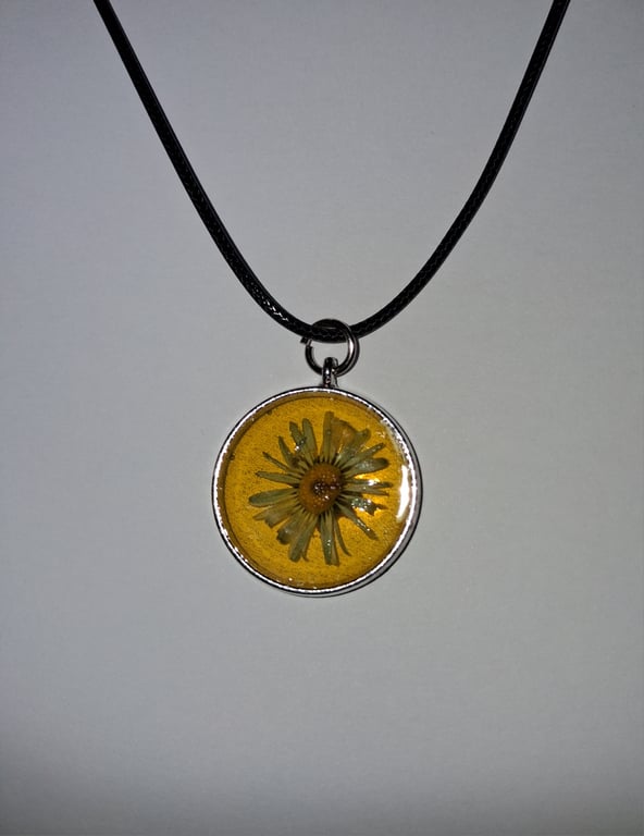 Handmade yellow daisy pendant on black waxed cord