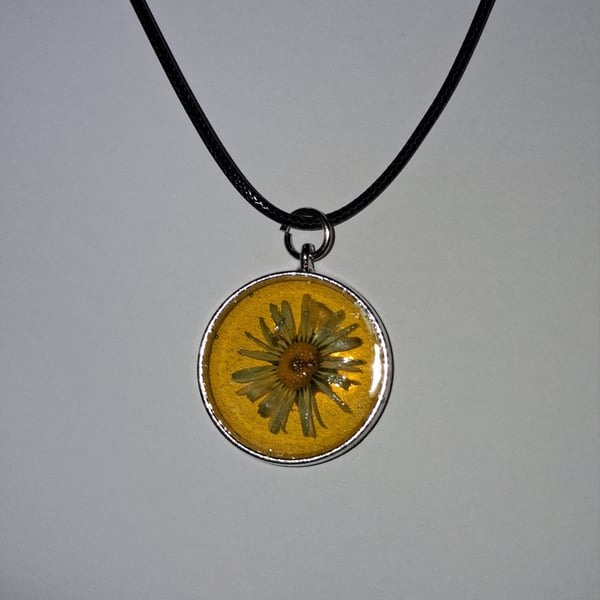 Handmade yellow daisy pendant on black waxed cord