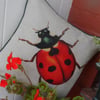Ladybird print cushion. Linen mix insect pillow.