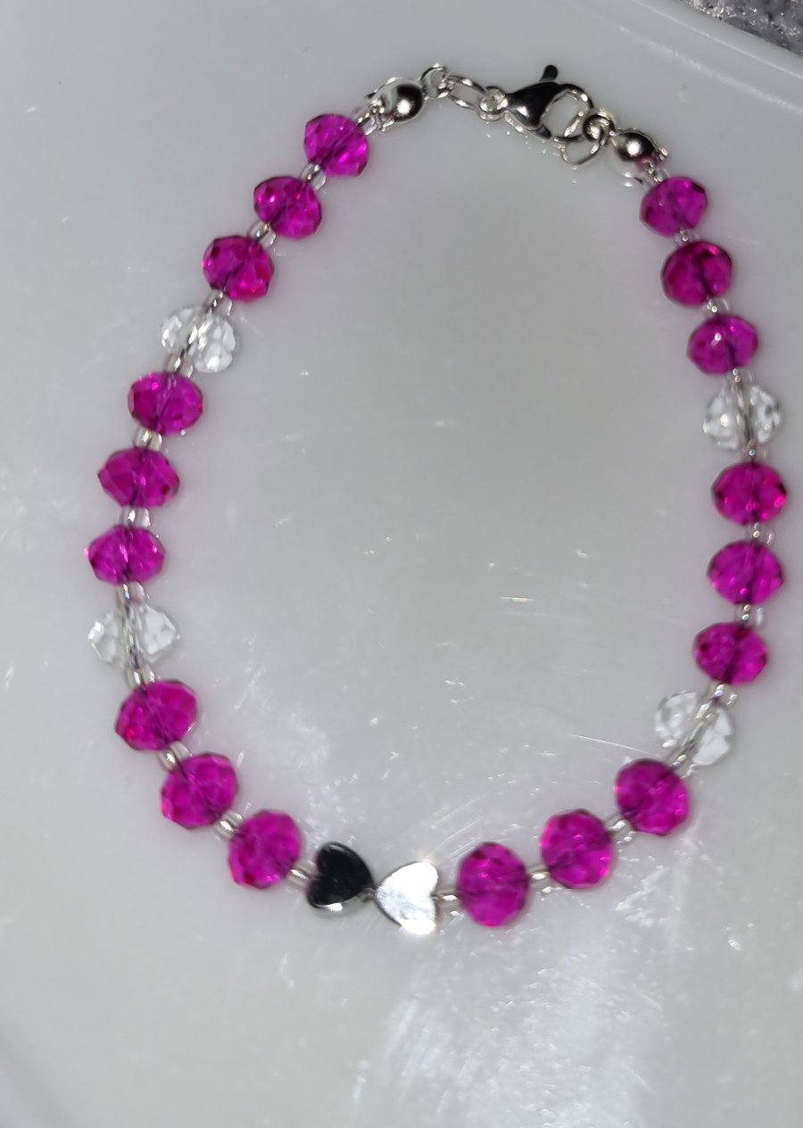 Kids bracelet with bright pink and clear faceted rondelle and metal hearts
