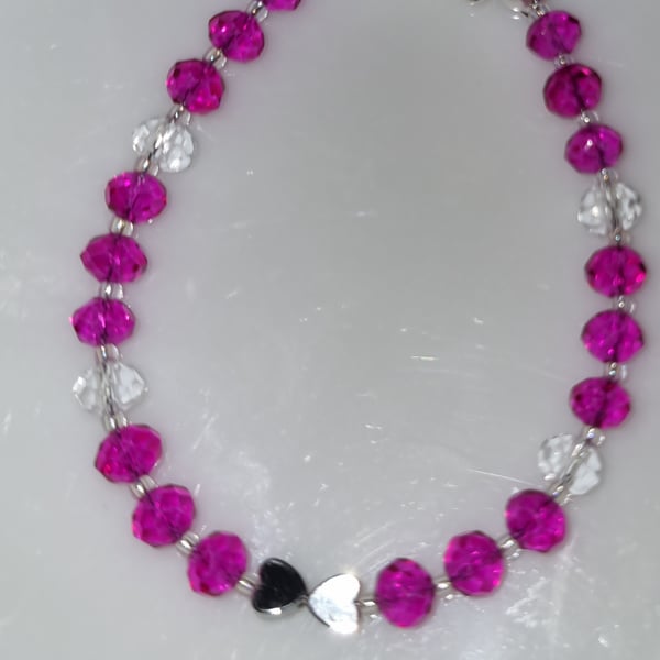 Kids bracelet with bright pink and clear faceted rondelle and metal hearts