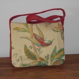 Red satchel messenger style bag with bird and floral front